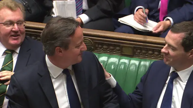 George Osborne pats David Cameron on the back