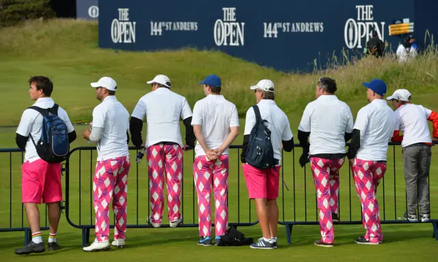 Spectators wearing brightly coloured trousers at The Open