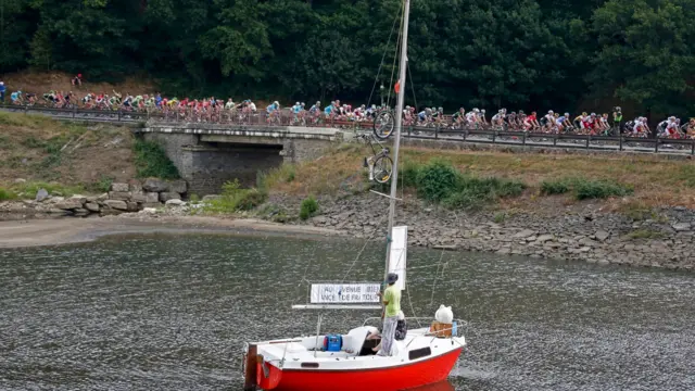 Riders pass sailboat