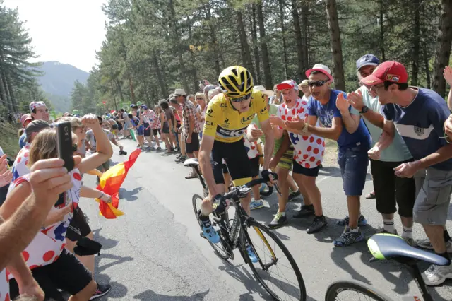 Chris Froome rides through the crowd