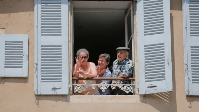 Spectators cheer on riders during stage 15