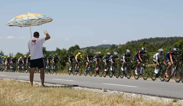 The main pack cycle past a spectator