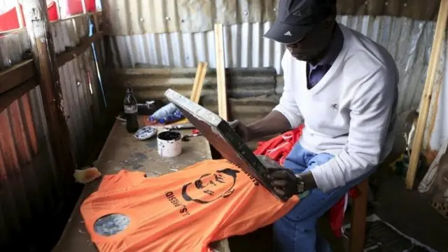 Man screen printing shirt