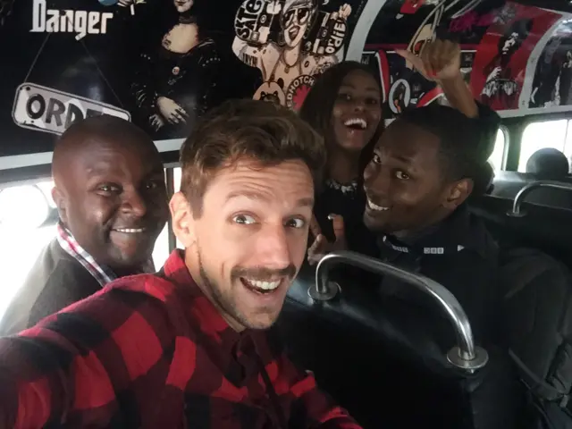 The team riding in a matatu, which is a Nairobi minibus that's often coated in graffiti and boasts very loud sound systems