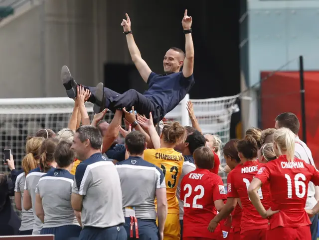 Mark Sampson celebrates with his players