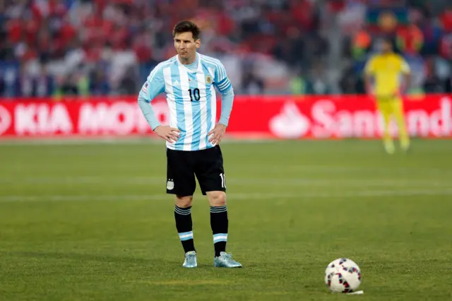 Lionel Messi stands over the ball