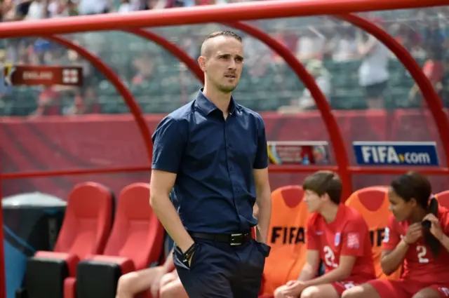 Mark Sampson looks on