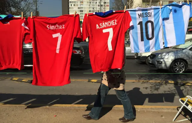 Chilean and Argentine shirts are displayed on a street in Santiago