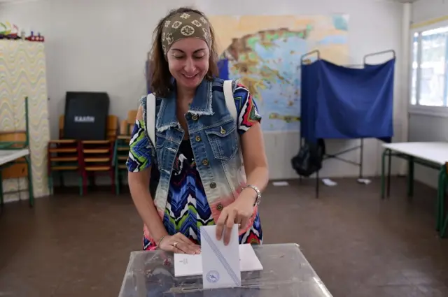 A Greek woman casts her ballot at a polling station during a referendum on austerity measures in Athens 5 July 2015