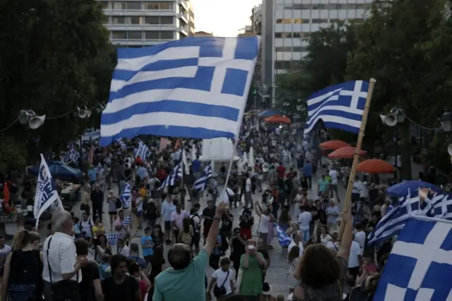 Supporters of the No vote wave Greek flags after the referendum"s exit polls at Syntagma square in Athens, 5 July 2015.