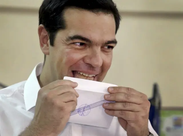 Greek Prime Minister Alexis Tsipras licks his ballot envelope before voting at a polling station in Athens, Greece 05 July 2015