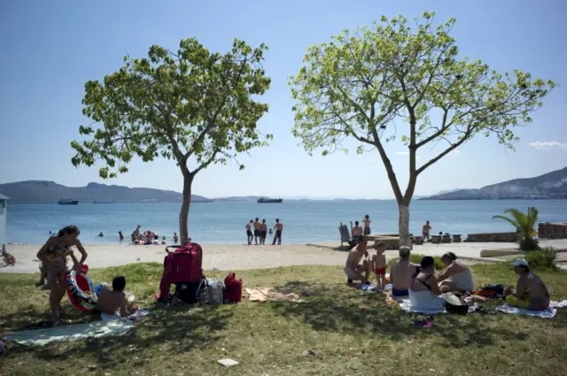 People enjoy the good weather at the beach of Elefsina, near Athens, Greece 5 July 2015