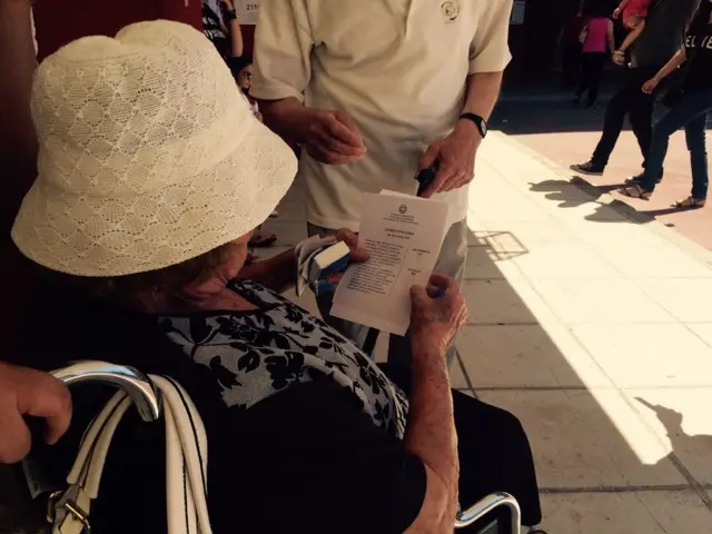 Greek woman looks at her ballot paper