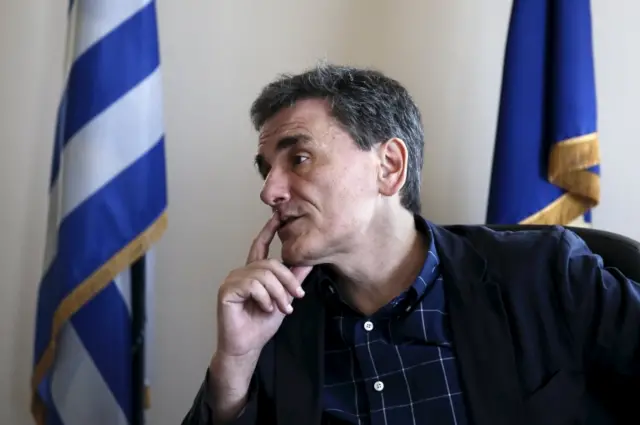 Deputy Foreign Minister and coordinator of the negotiating team for the talks between Greece and its international lenders, Euclid Tsakalotos, gestures during an interview with Reuters at his ministerial office in Athens 17 June 2015