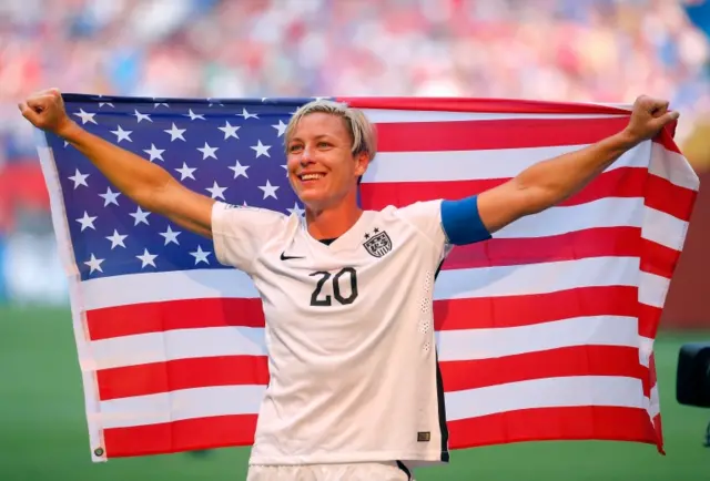 Abby Wambach celebrates with the American flag