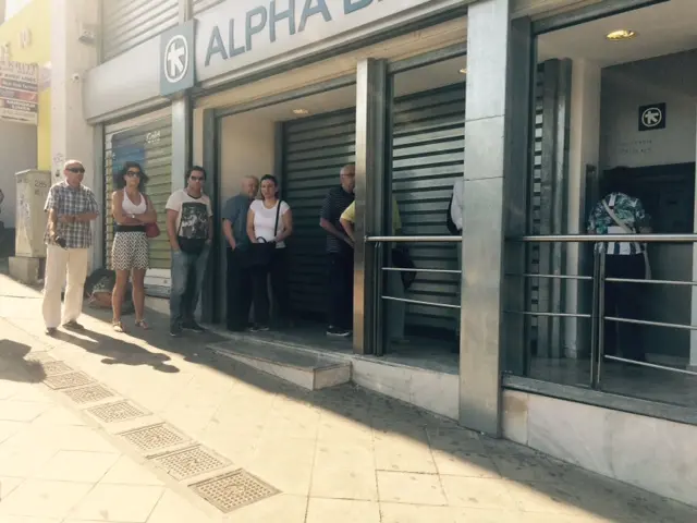 She sends us this view of Syntagma square as people queue for their daily cash