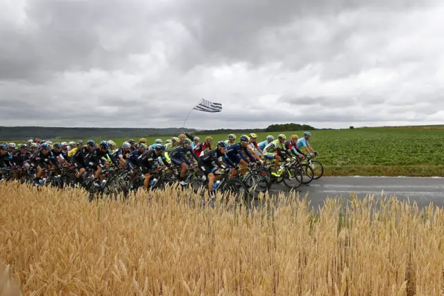 The riders cycle toward the finish line