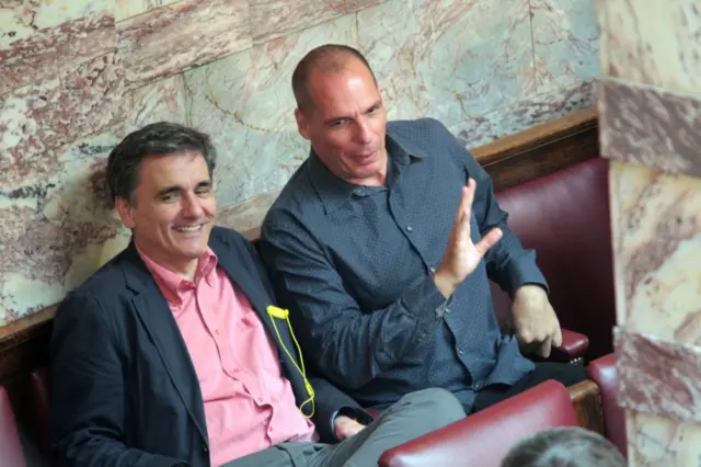 The Finance Minister of Greece, Euclid Tsakalotos (L), and his predecessor, former Finance Minister Yanis Varoufakis