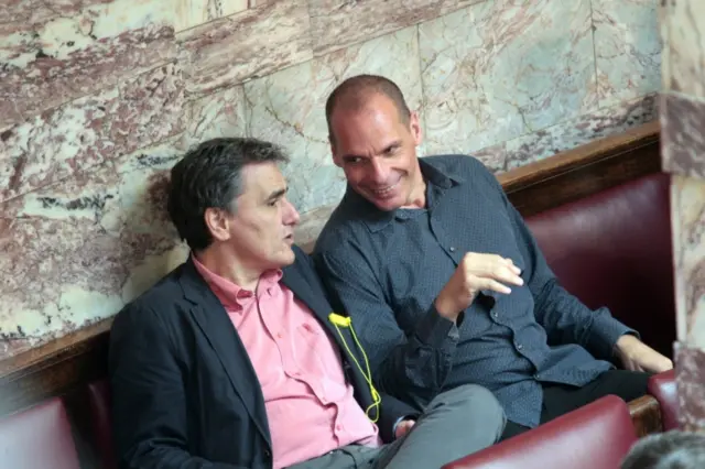 The Finance Minister of Greece, Euclid Tsakalotos (L), and his predecessor, former Finance Minister Yanis Varoufakis