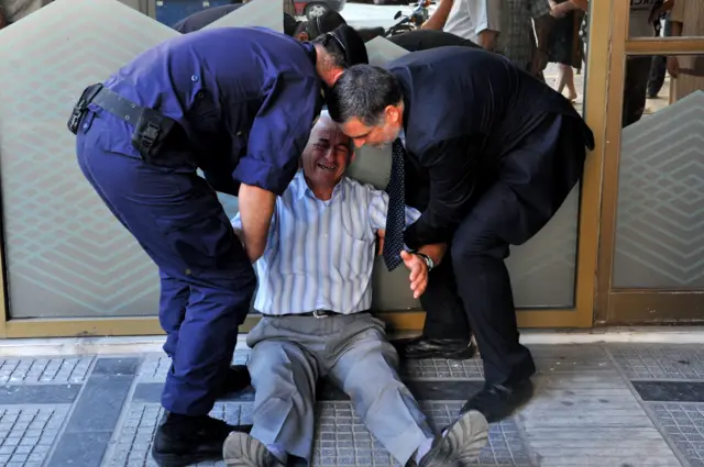 Greek pensioner outside bank