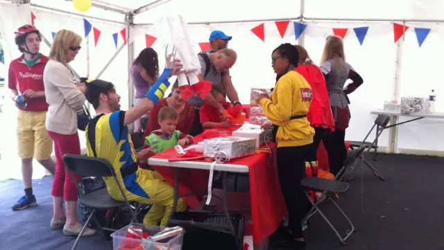 people making crafts in tent