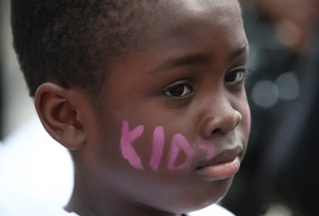 A child with Kids Company written on his cheeks