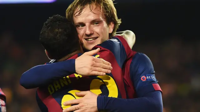 Ivan Rakitic hugs Dani Alves