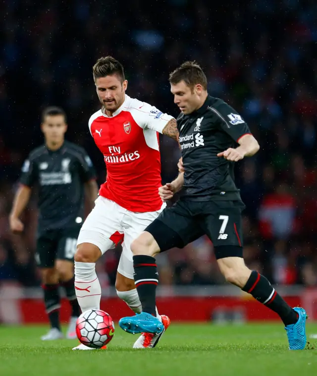 James Milner battles against Olivier Giroud