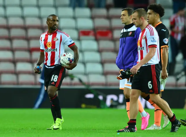 Jermain Defoe leaves the field at full-time with the match ball