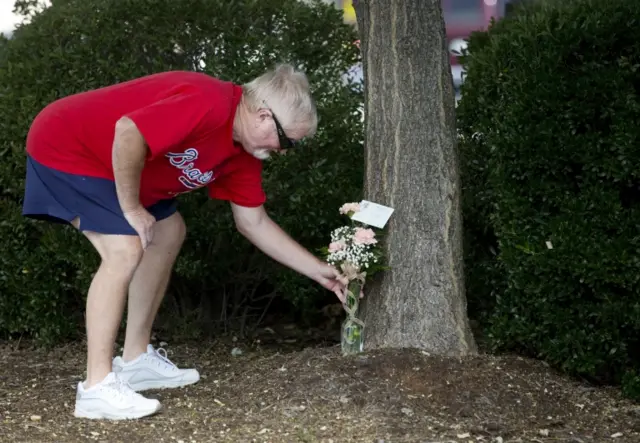 Rodney Booth, a dedicated viewer of WDBJ, lays flowers near the news channel's office