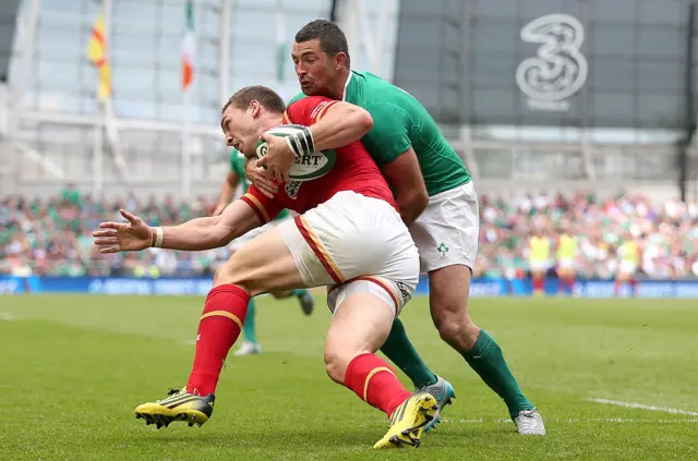 Ireland's Rob Kearney bundles George North into touch