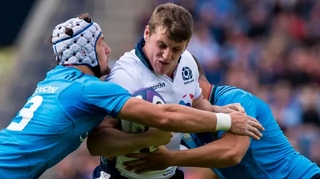 Mark Bennett is tackled by Michele Campanaro and Luca Morisi