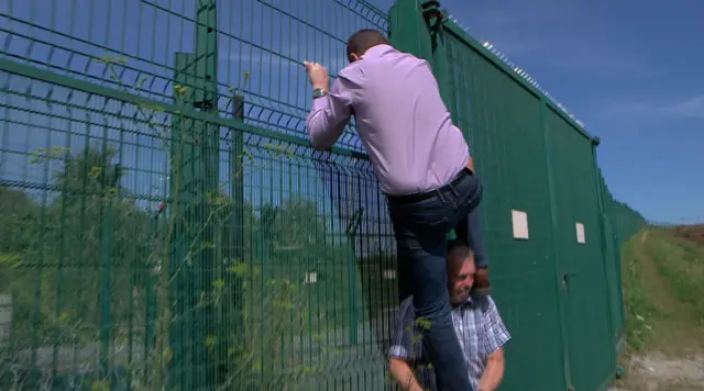 UKIP MEP Mike Hookem climbs a security fence near the Eurostar railway to prove how easy it is to access the tracks