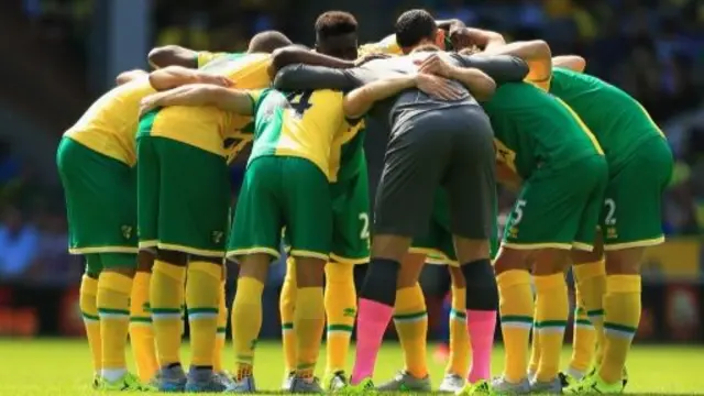 Norwich City players form a huddle
