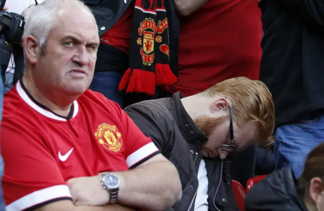 A Manchester United fan sleeps