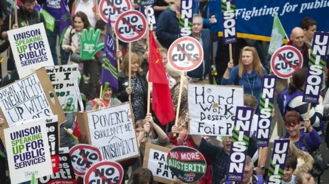 Demonstrators protesting against spending cuts