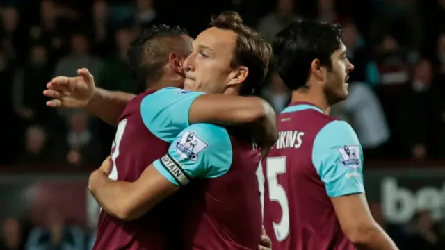 Mark Noble hugs Dimitri Payet