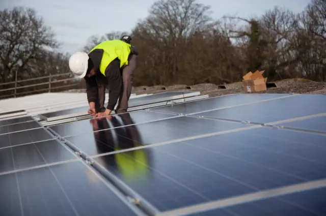 Engineer fitting solar panels