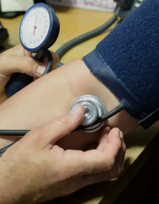 Doctor checking a patient's blood pressure