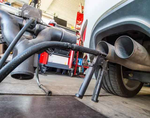 A probe of a device used for Diesel engine emission tests has been attached to an exhaust pipe of a VW Golf 2.0 TDI car in a repair shop in Frankfurt/Oder, Germany, 21 September 2015.