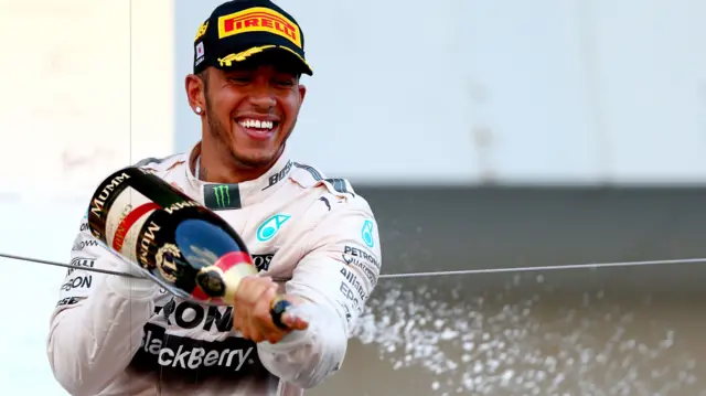 Lewis Hamilton sprays champagne