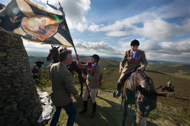 Royal Burgh Standard Bearer Martin Rodgerson and his Burleymen attendants, Three Brethren cairns summit, during the Common Riding festivities in Selkirk, Scotland, 2013 from the series Unsullied and Untarnished