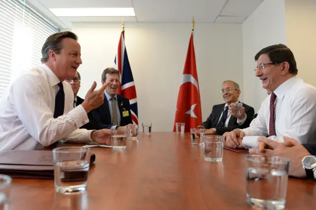 Prime Minister David Cameron (left) speaks with the Prime Minister of Turkey Ahmet Davutoglu