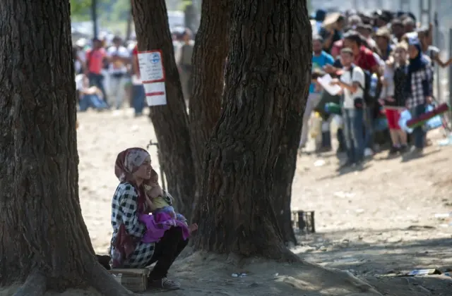 Migrants wait for Macedonian police to allow them to cross into Macedonia at the border between Greece and Macedonia near the town of Gevgelija, on September 3, 2015