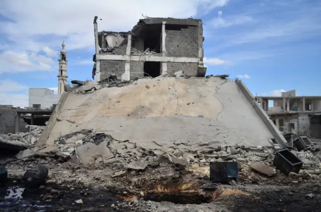 Damaged buildings and a minaret in central Syrian town of Talbisseh in Homs province