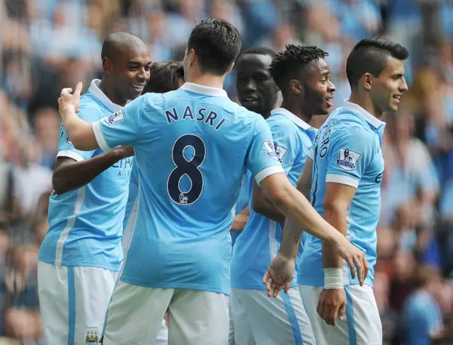 Fernandinho (left) celebrates with Man City team-mates