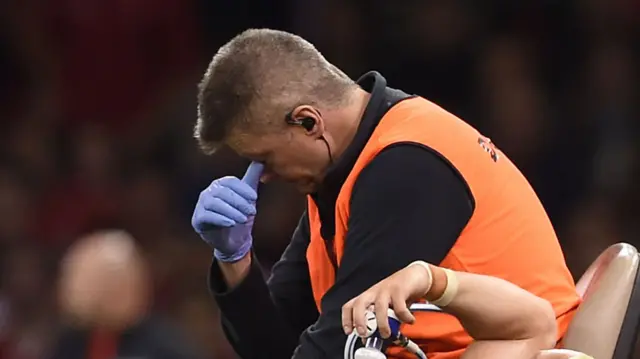 A steward taking off Leigh Halfpenny