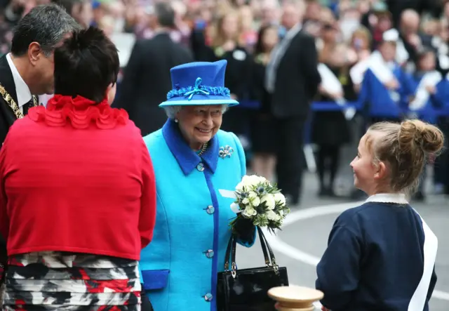Queen smiles as she meets a well-wisher in Edinburgh