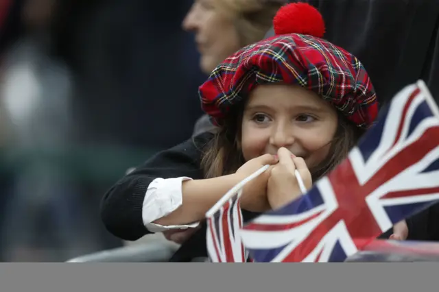 Emily Smith holds a union jack and smiles