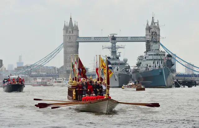 A Royal River Salute sails under Tower Bridge in London